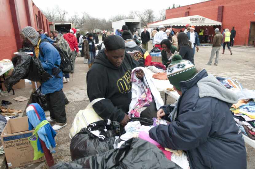 Guests looked through donated clothing at BigHeart Ministries' Christmas celebration, a...