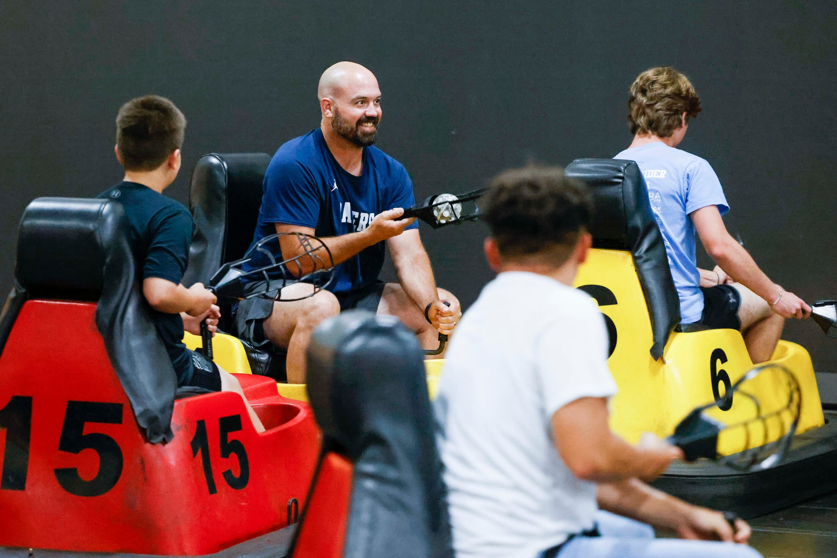 L.D. Bell High School football head coach T.J. Dibble (left center) engage during a...