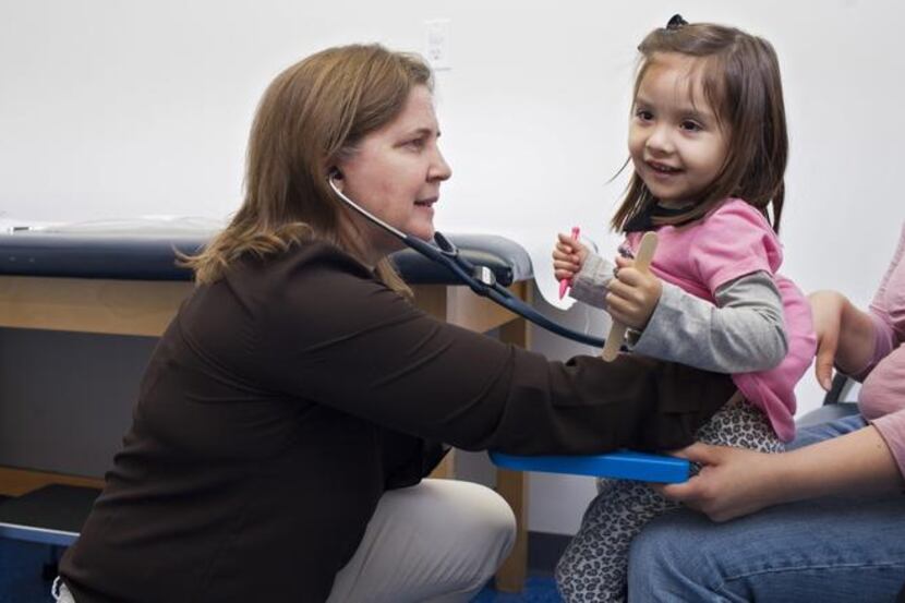 Two-year-old Violet Ayala gets a check-up from Dr. Lindsay Irvin, who recently spent $70,000...
