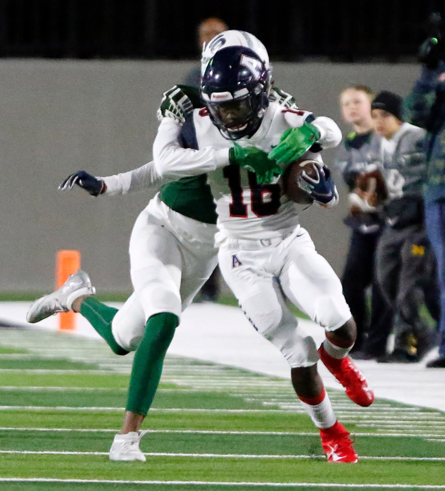 Allen High School wide receiver Touray Green (16) is taken down by Prosper High School...