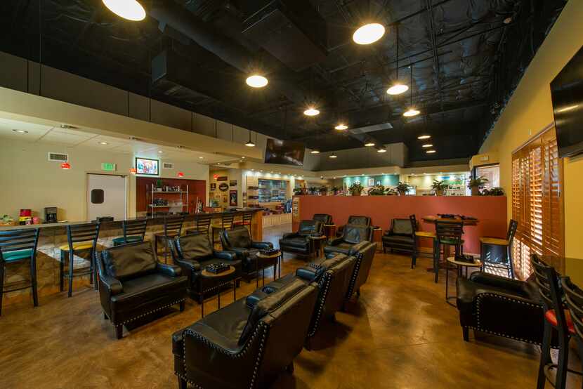 The customer lounge at Renegade Cigars, with black lounge chairs and barstools.