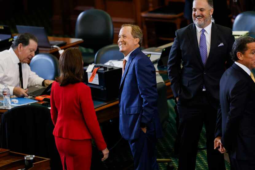 (From left) Lawyer Dan Cogdell sits as Sen. Angela Paxton, R-McKinney, greets her husband,...