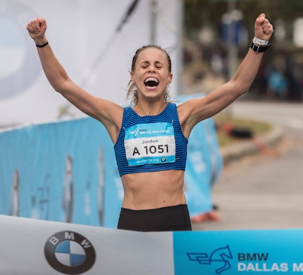 Jordan Snyder celebrates as she crosses the finish line as the female winner of the BMW...