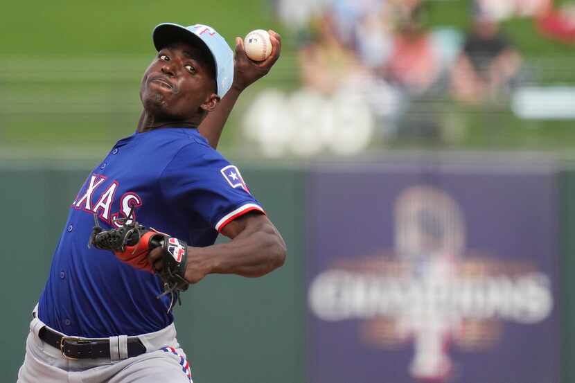 Texas Rangers pitcher Emiliano Teodo  delivers during the fourth inning of a spring training...
