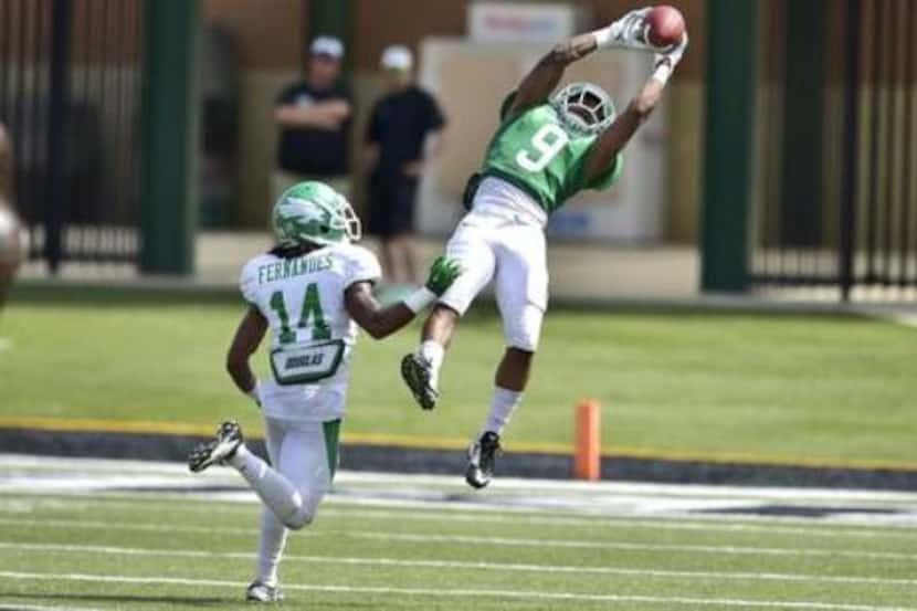 North Texas wide receiver Carlos Harris hauls in a pass during the Mean Green's spring game...