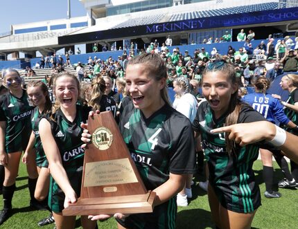 Southlake Carroll players celebrate after winning during a Class 6A Region I championship...