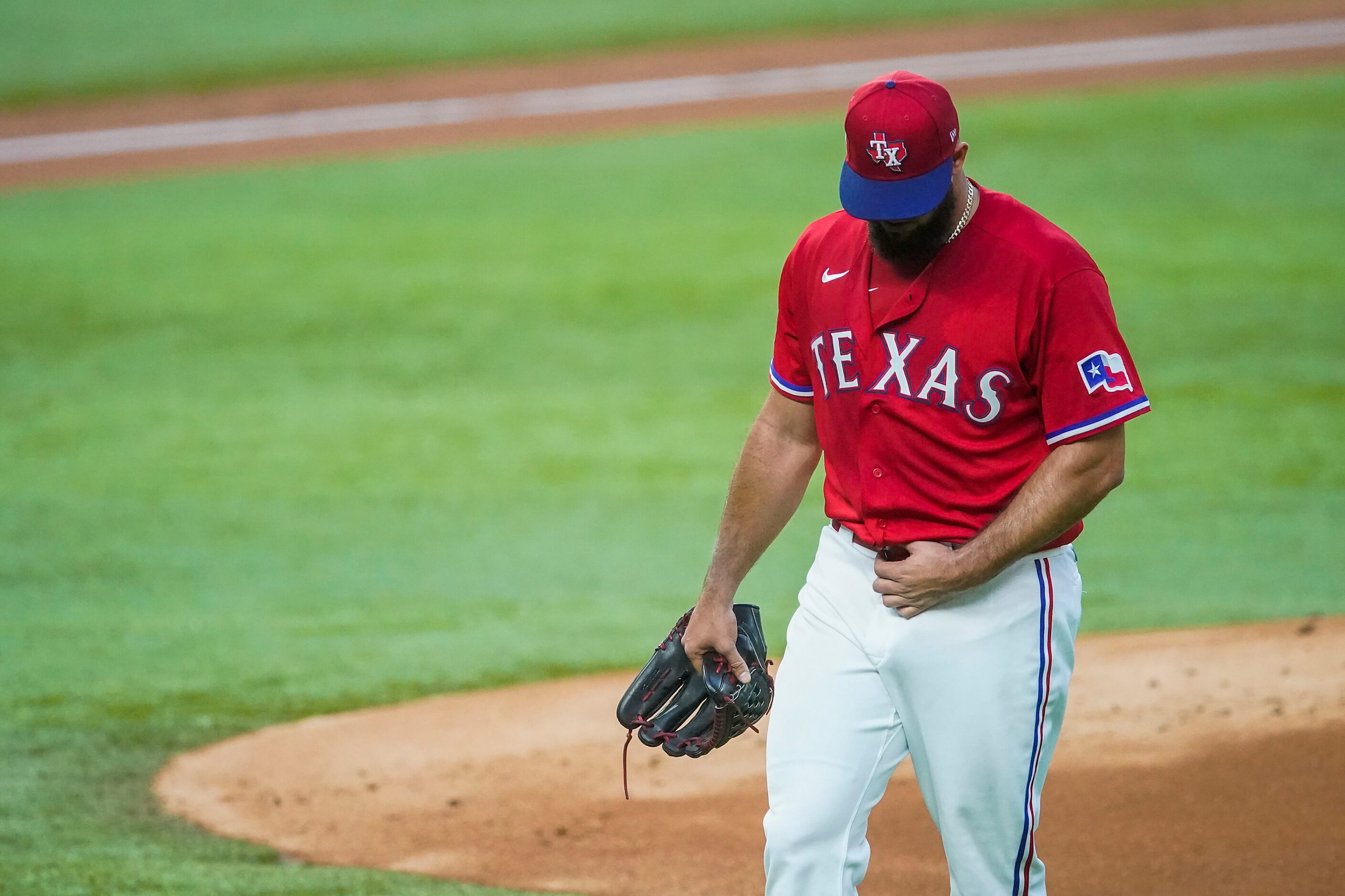 Texas Rangers starting pitcher Luis Garcia leaves the game after giving up four runs and...