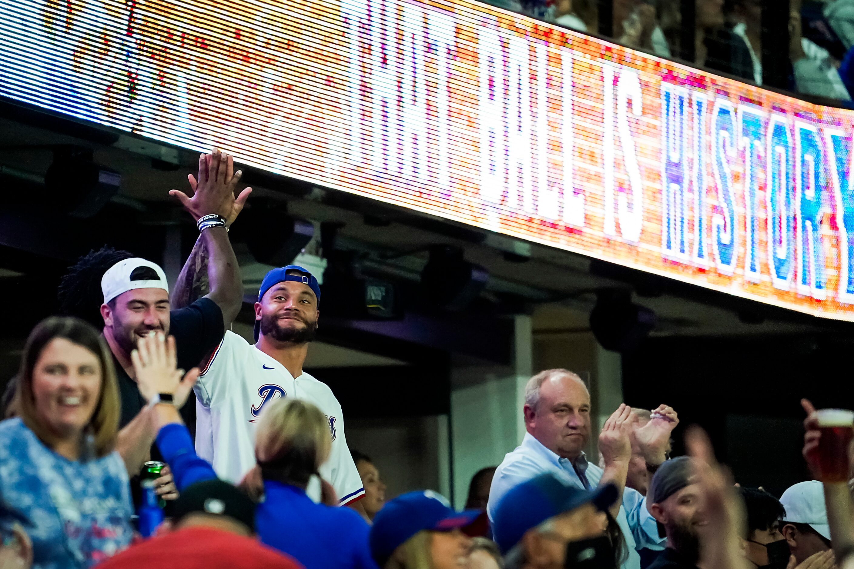 Dallas Cowboys quarterback Dak Prescott joins the celebration with other Texas Rangers fans...