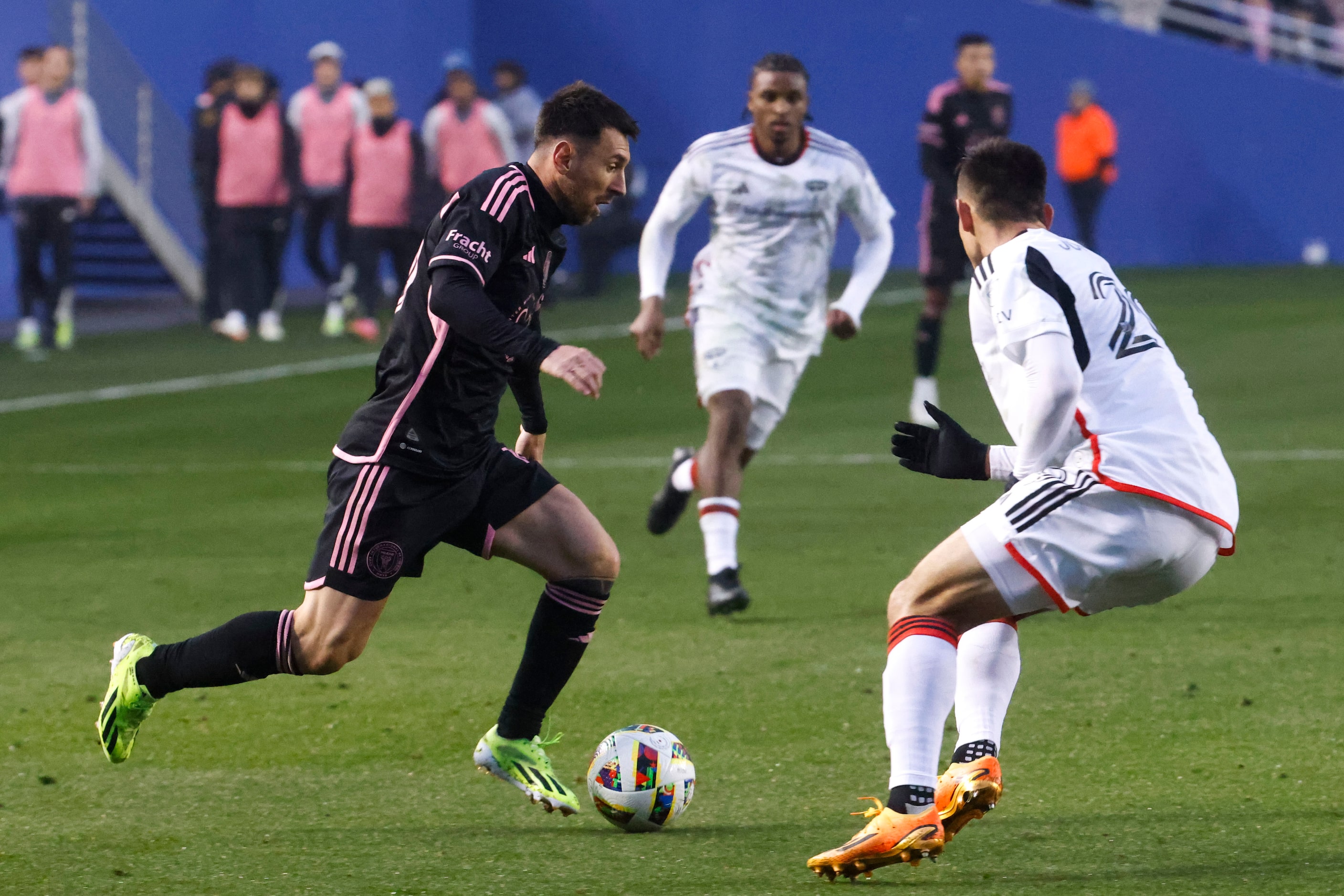 Inter Miami forward Lionel Messi (left) attempts to run past FC Dallas defender Sam Junqua...