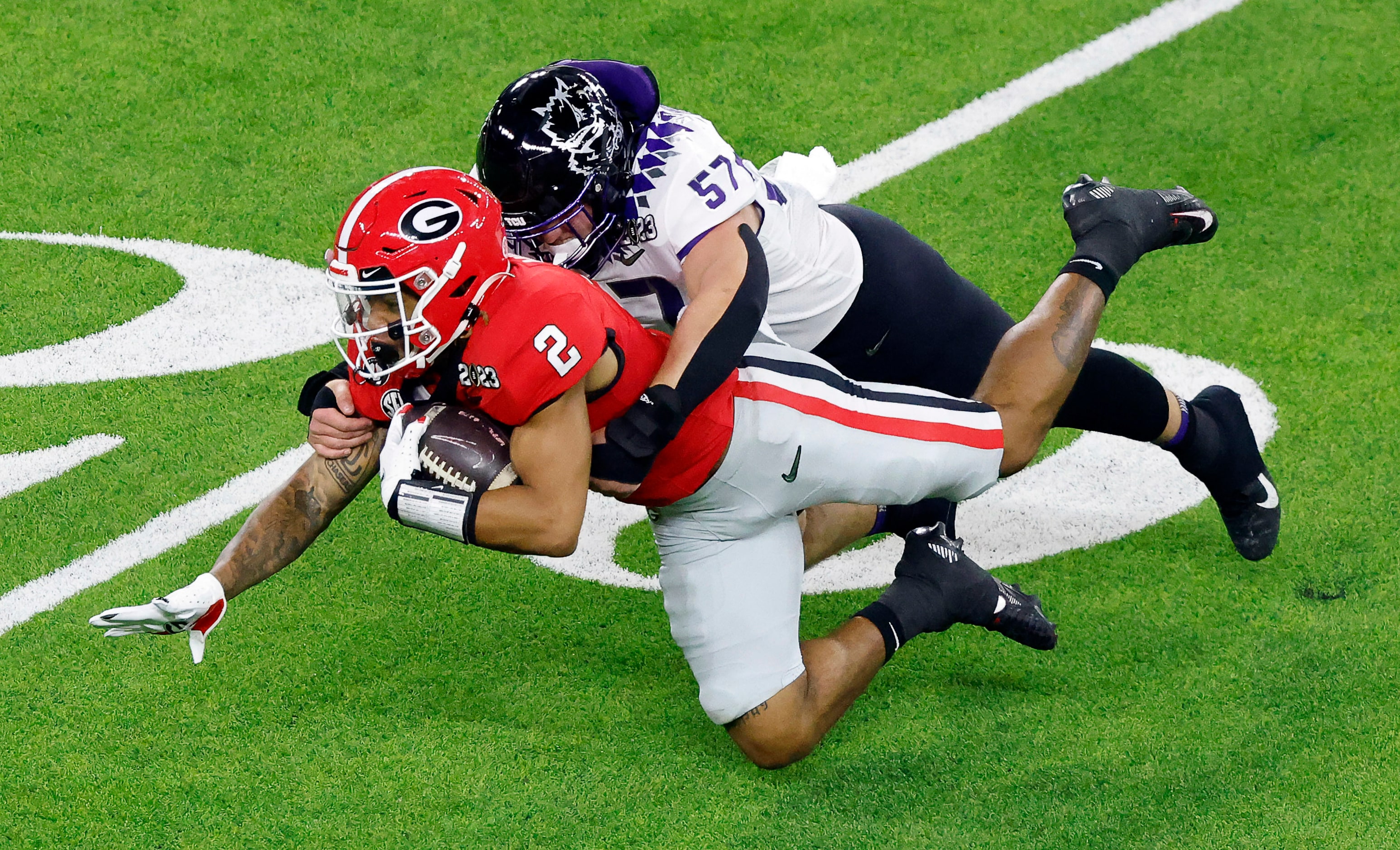 TCU Horned Frogs linebacker Johnny Hodges (57) tackles Georgia Bulldogs running back Kendall...