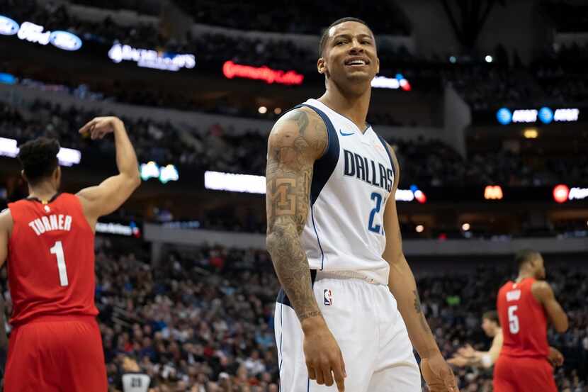 Dallas Mavericks guard Trey Burke reacts after bing called for a foul during the second half...