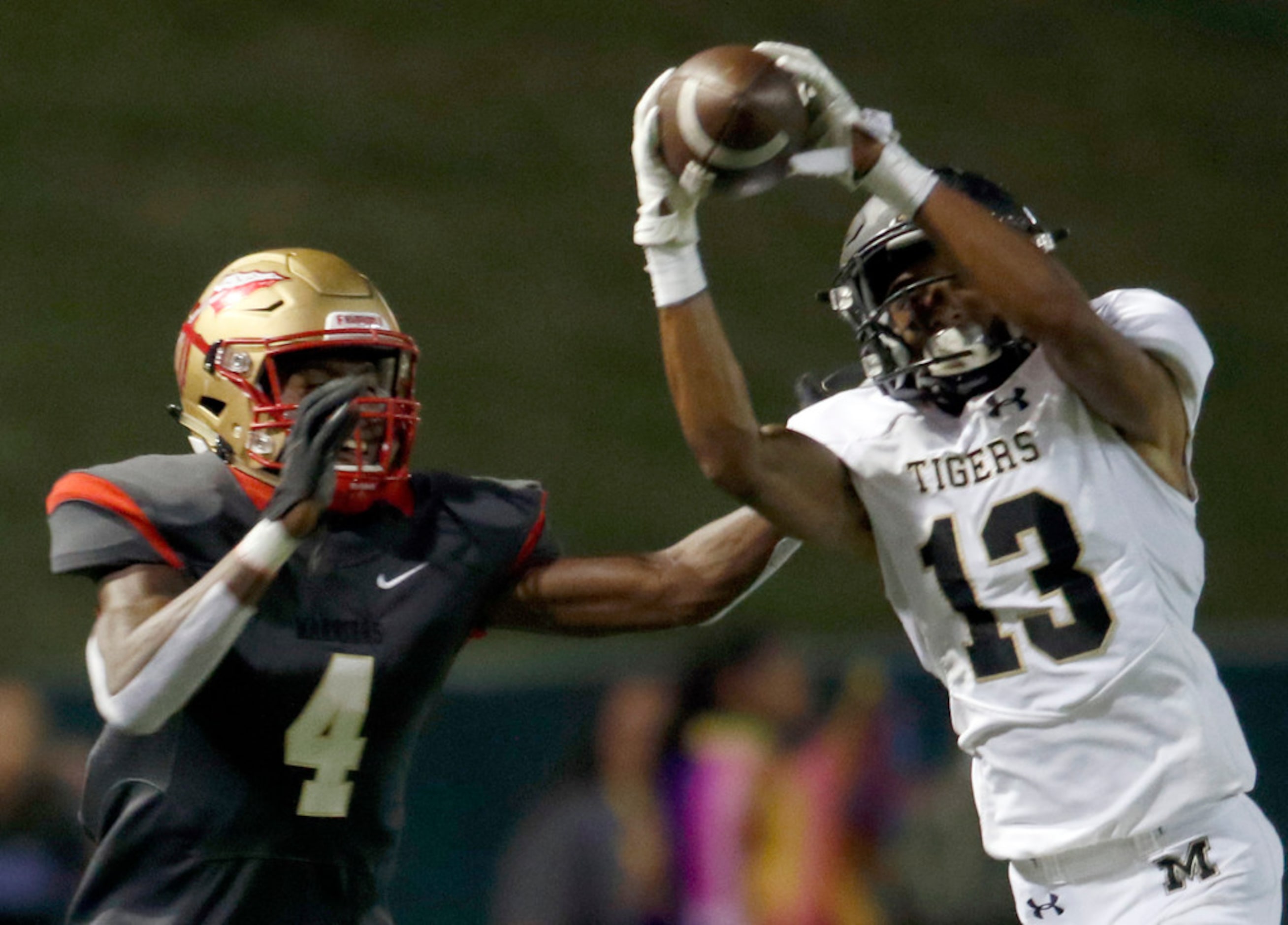 Mansfield defensive back David Godsey (13) reaches in front of South Grand Prairie receiver...