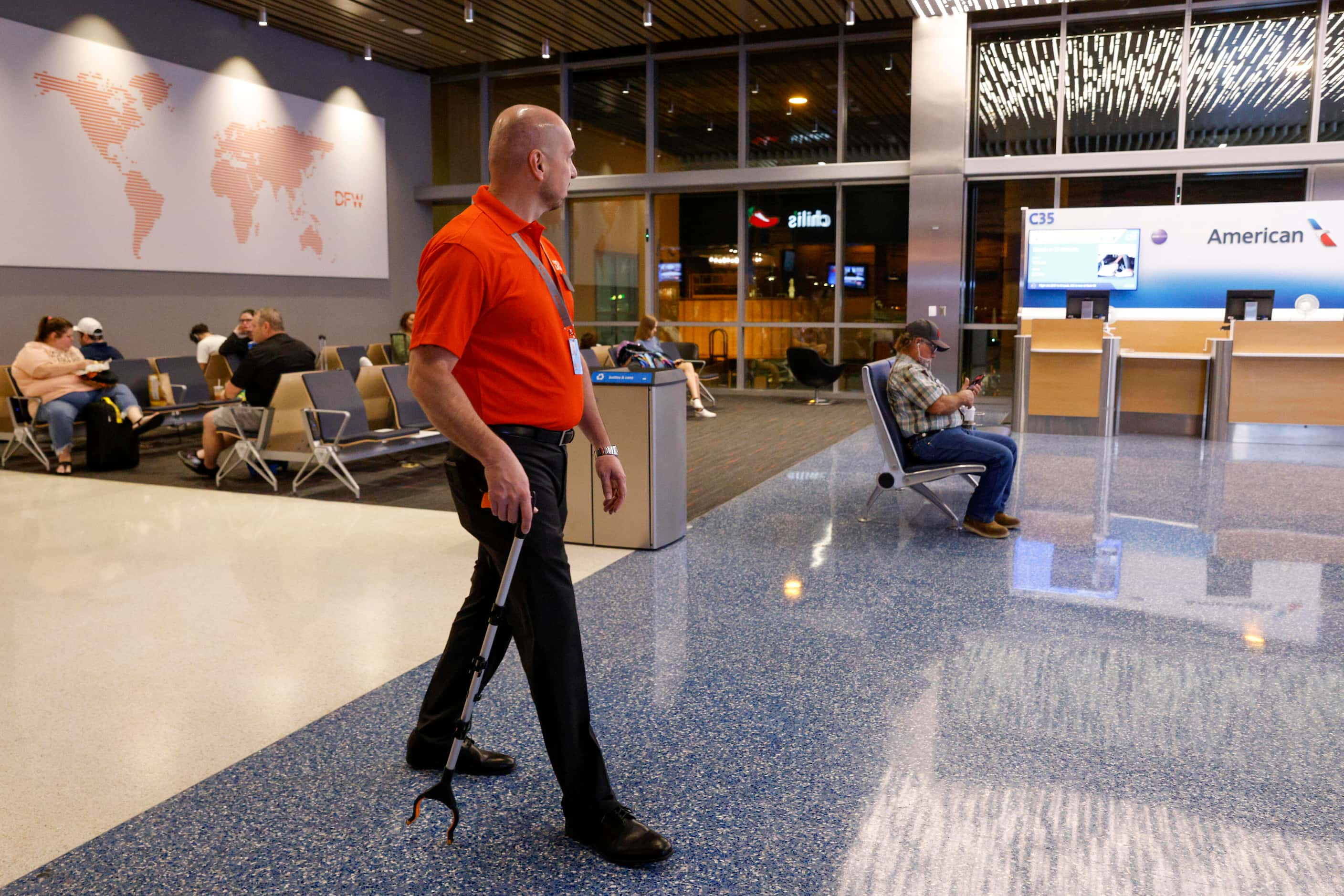 Supervisor of terminal experience Nic Arifi walks Terminal C with his picker as he looks to...