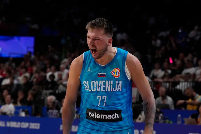 Slovenia guard Luka Doncic (77), right,reacts after getting fouled by a Slovenia player in...