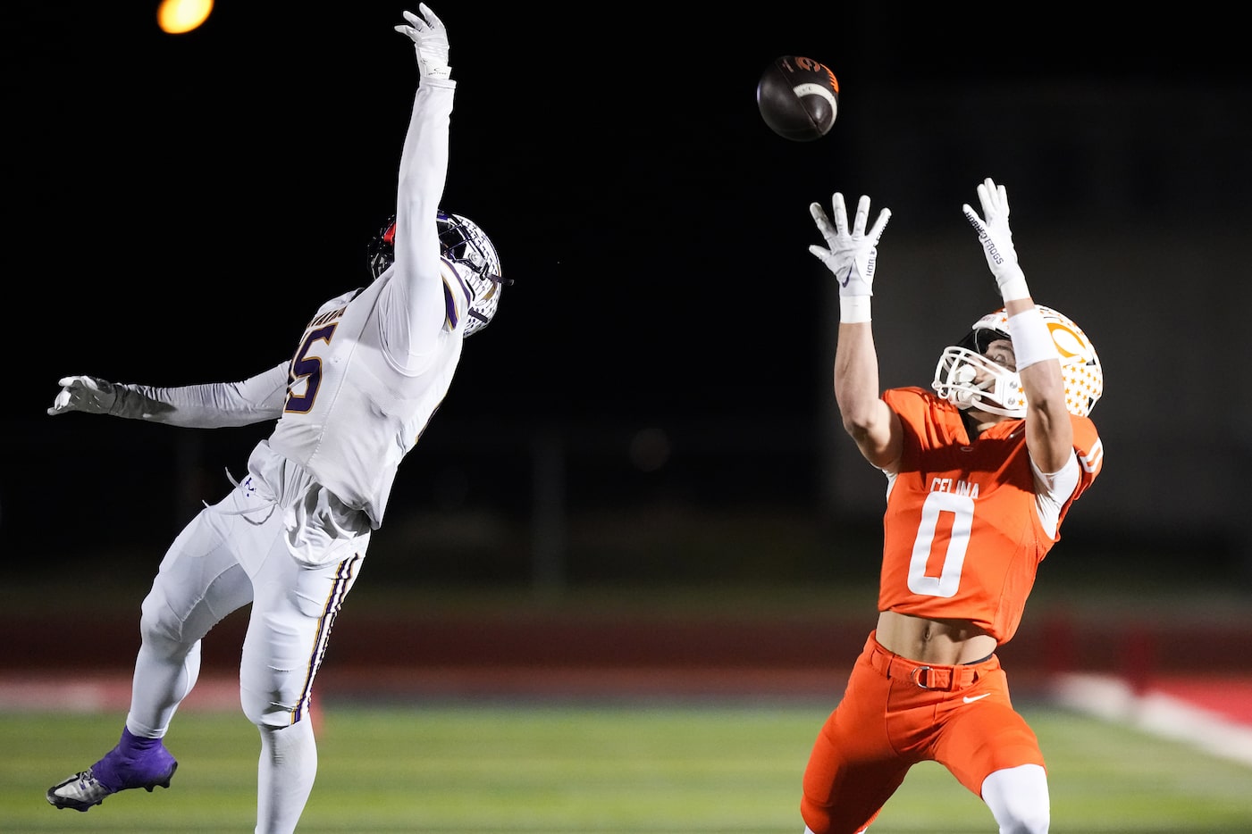 Celina's Ethan Rucker (0) hauls in a 53-yard touchdown pass as Alvarado's Lance Sansom (15)...