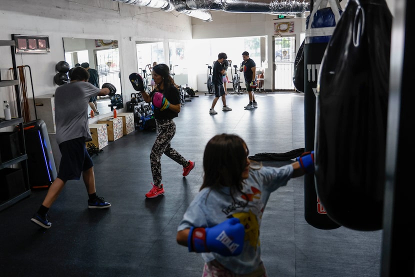 Amanda Alvarez, a salsa teacher and boxing lover, trains Eduardo Soto (left) during a boxing...