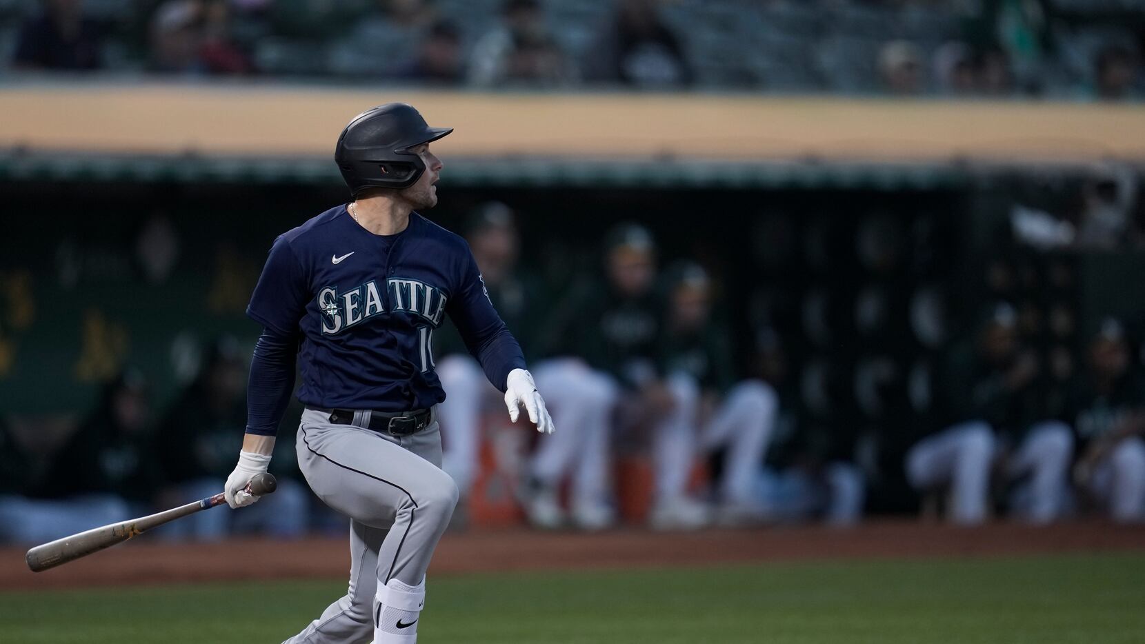 Seattle Mariners' Jarred Kelenic watches his RBI single against the Oakland Athletics during...