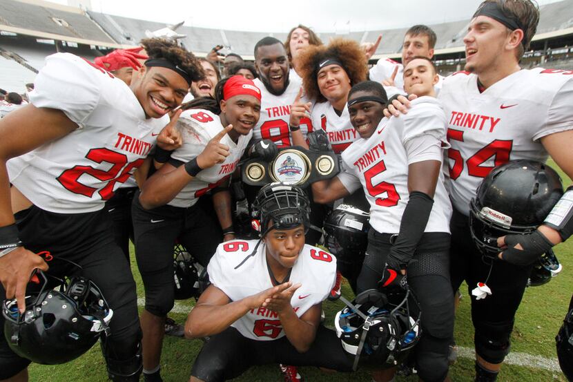 A euphoric group of Euless Trinity players pose to document the moment after being presented...