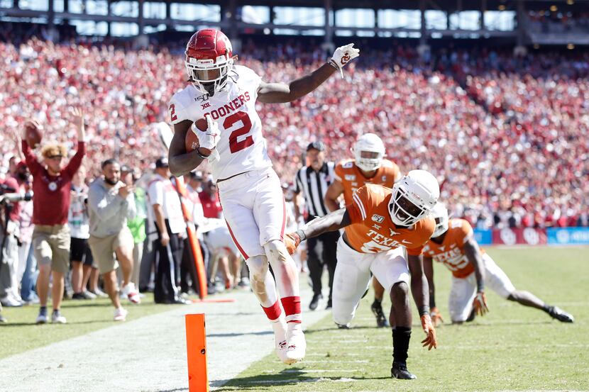 FILE - Oklahoma wide receiver CeeDee Lamb (2) scores a touchdown after beating Texas...