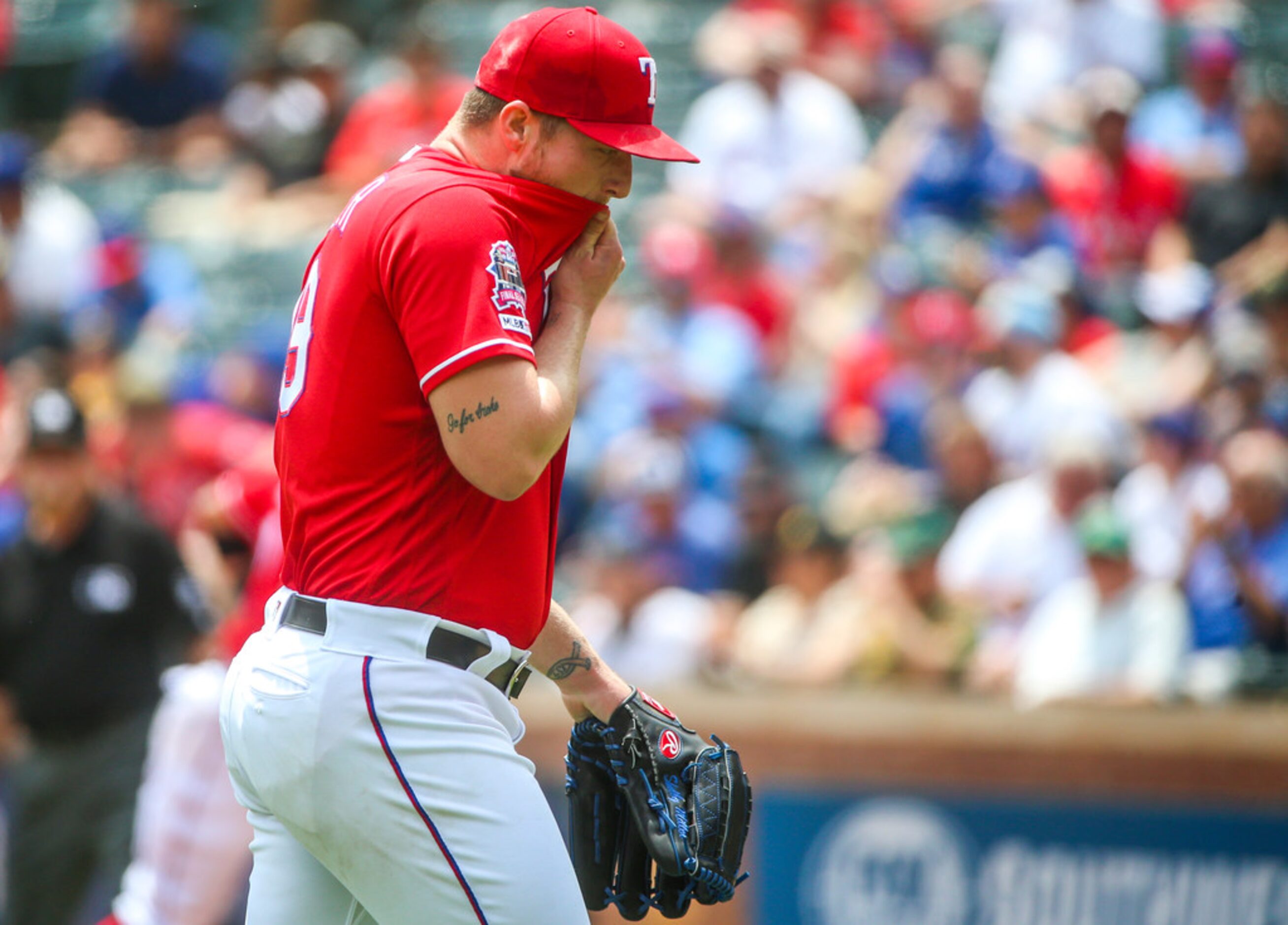 Texas Rangers starting pitcher Shelby Miller (19) walks back to the dugout after pitching in...