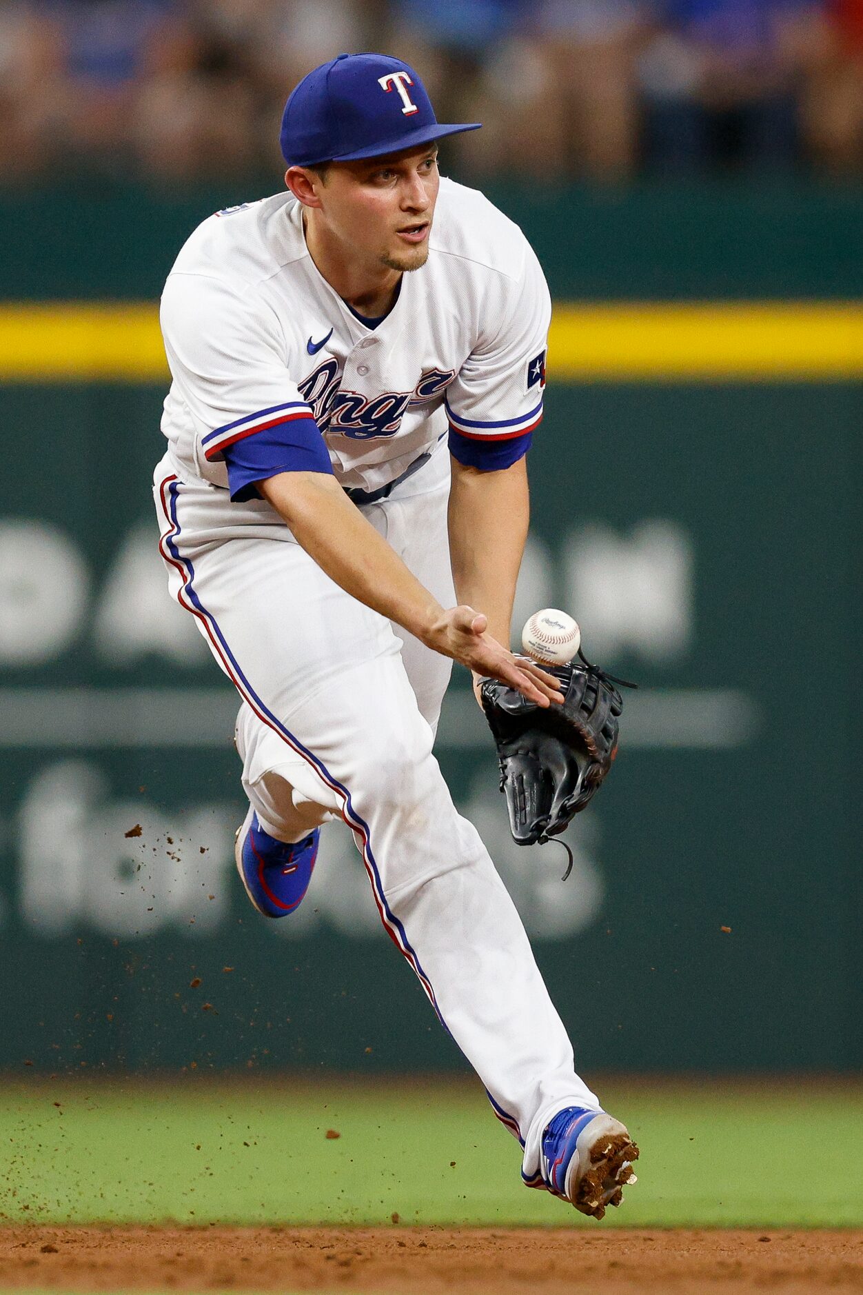 Texas Rangers shortstop Corey Seager (5) flips the ball to second baseman Marcus Semien (2)...