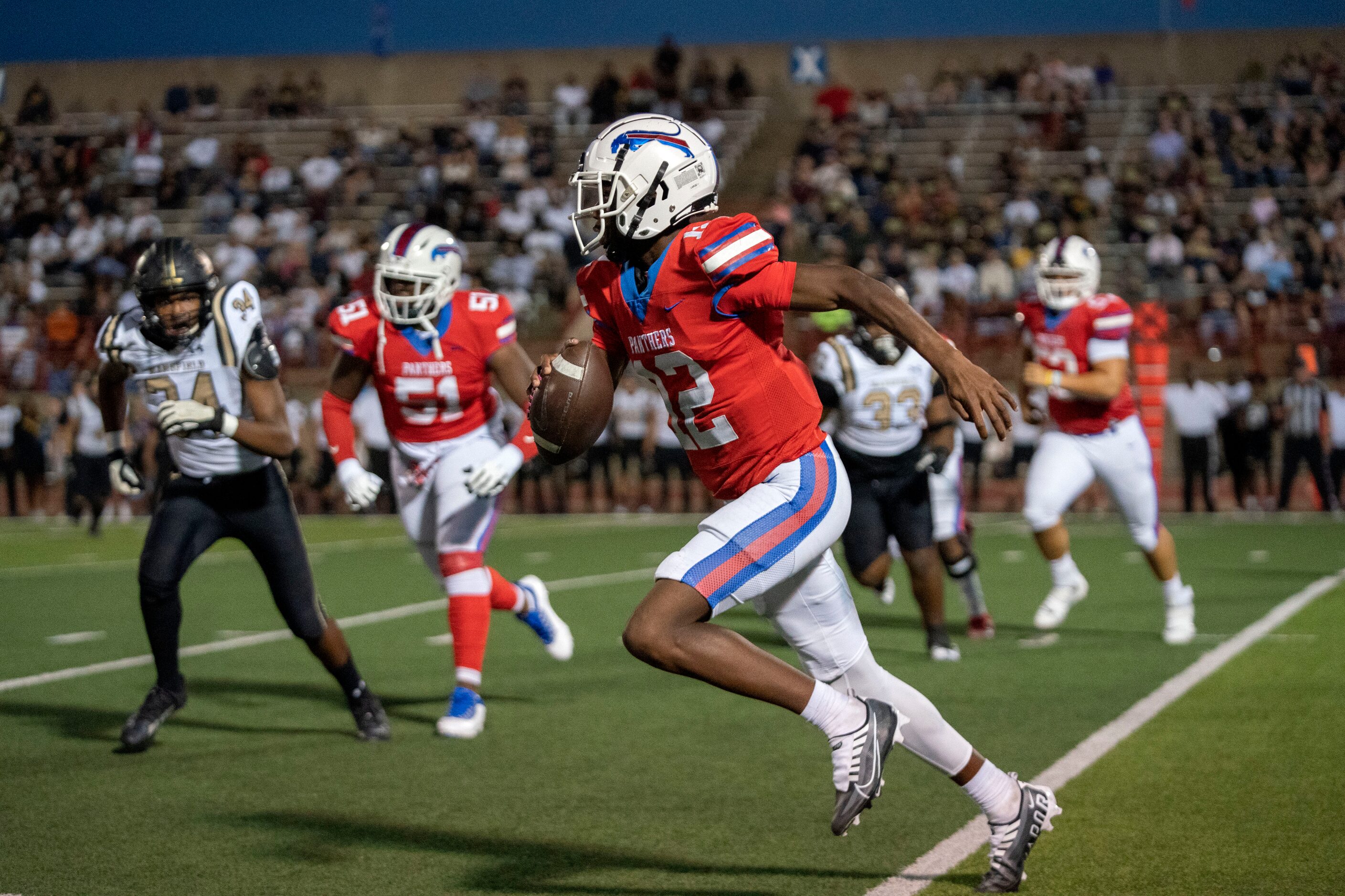 Duncanville sophomore quarterback Keelon Russell (12) scrambles during the first half of a...