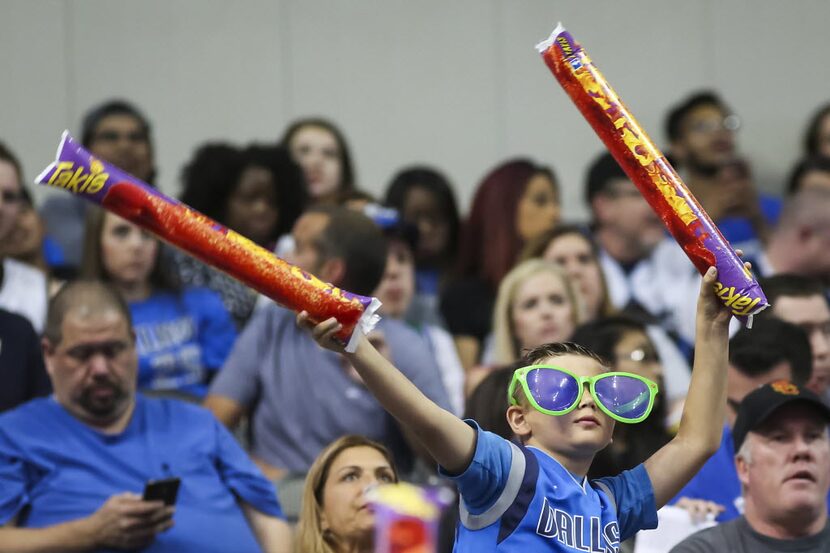 Dallas Mavericks fans cheer during pregame warmups before an NBA basketball game against the...