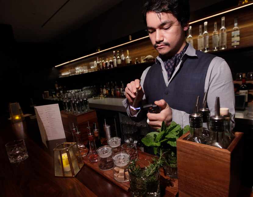 Bartender George Kaiho mixes drinks at Jettison in Dallas, on Dec. 7, 2016.