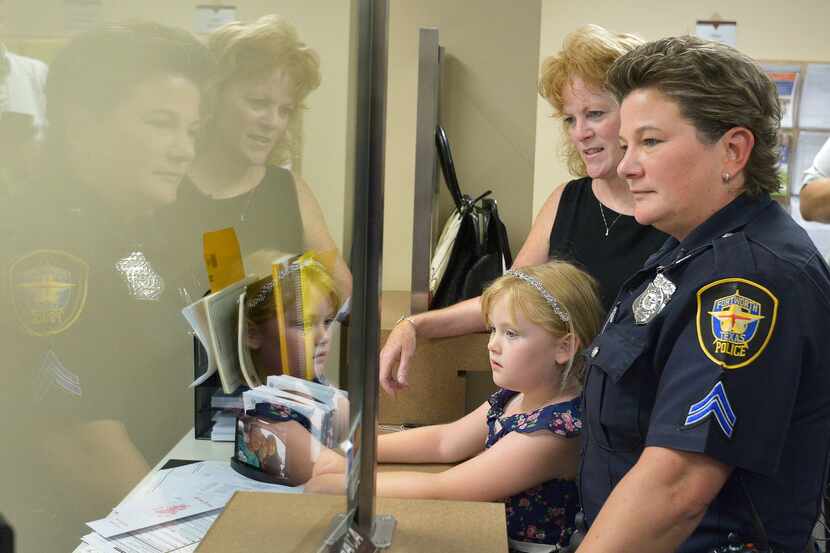 Fort Worth police Cpl. Tracey Knight and Shannon Knight, with their 6-year-old daughter,...