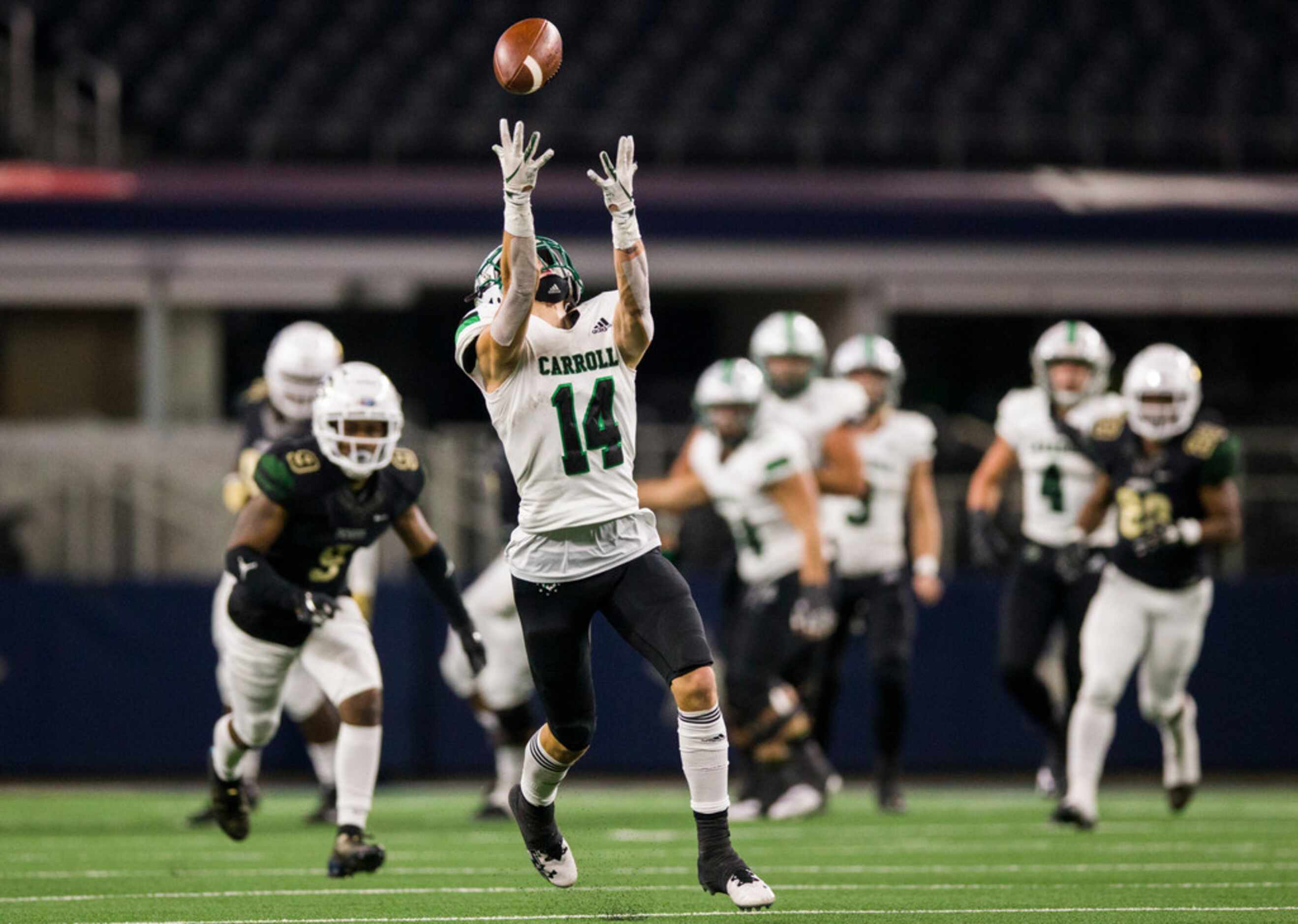 Southlake Carroll wide receiver Brady Boyd (14) reaches for a pass during the first quarter...