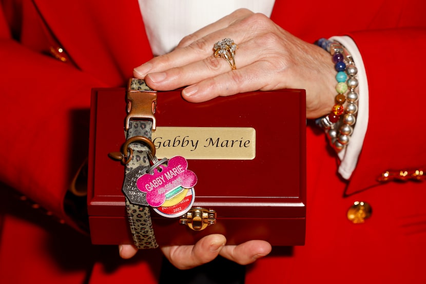 Donna Macey holds the urn carrying the ashes of her Yorkie, Gabby Marie, on Thursday, July...