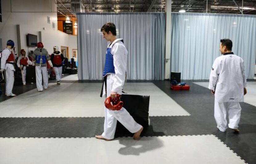 Coppell High School student Connor Wilson, 16, walks across the mat after a sparring session...