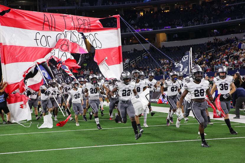Denton Guyer runs out before the Class 6A Division II state championship game against Austin...