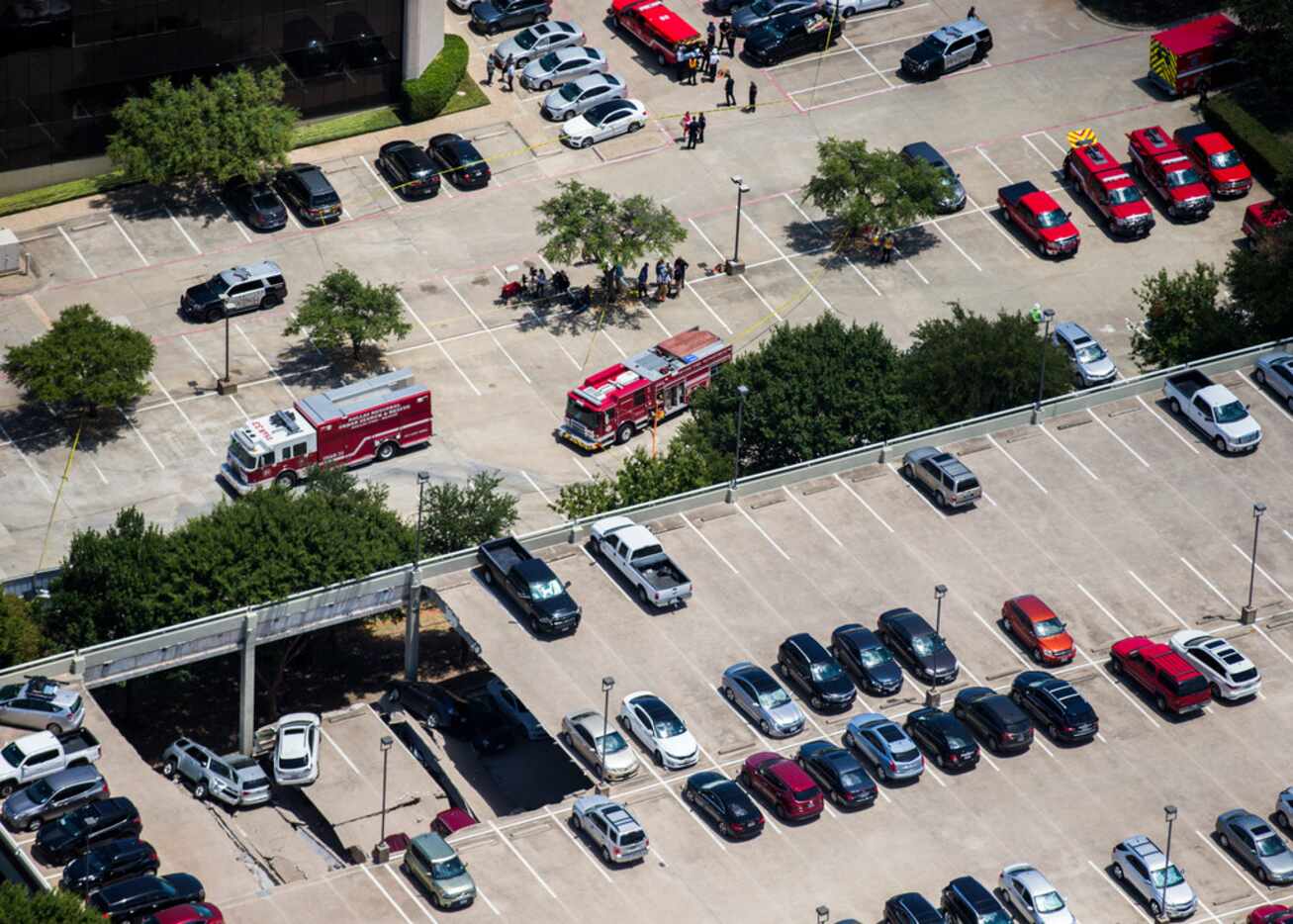 Emergency crews respond to a collapsed parking garage at 4545 Fuller Road in Irving on Tuesday.