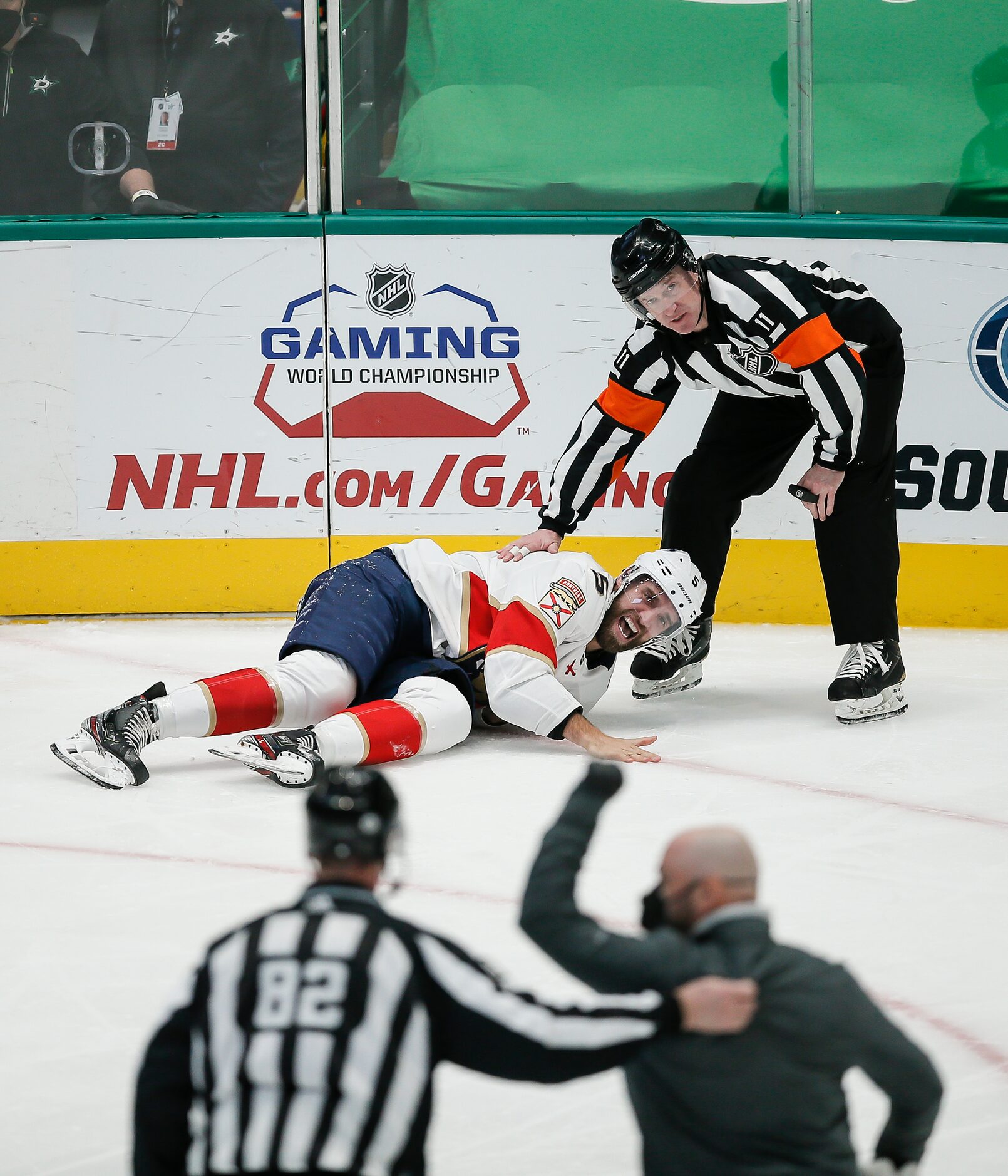 A Florida Panthers trainer rushes to the aid of defenseman Aaron Ekblad (5) after suffering...