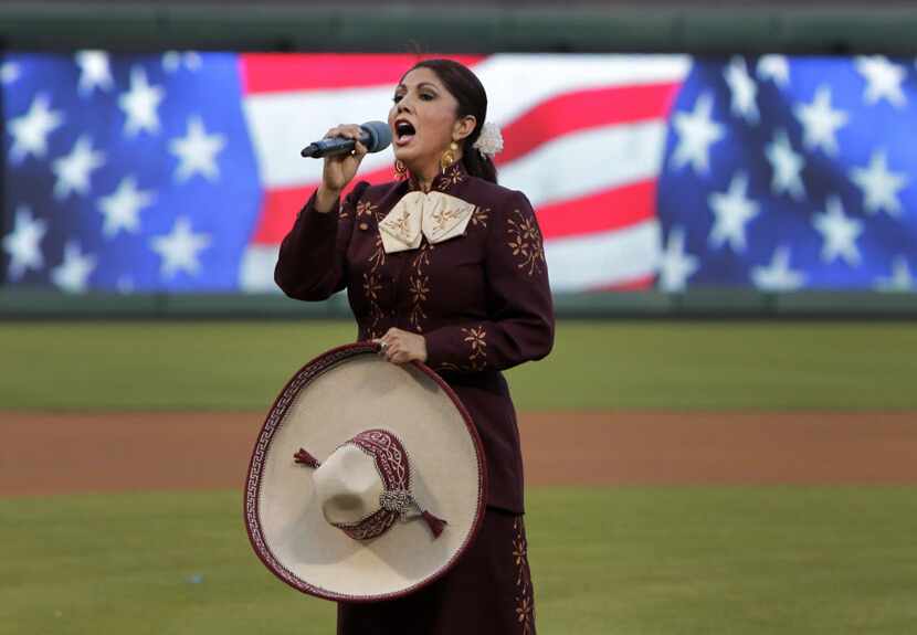 Norma Valles sings the U.S. national anthem before a Texas Rangers exhibition game against...
