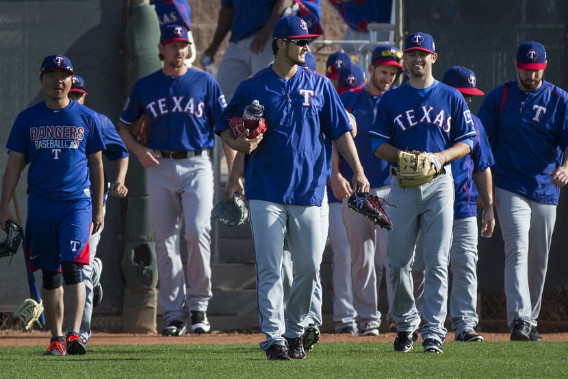 Texas Rangers pitcher Yu Darvish leads the way as Rangers players take the field for a...