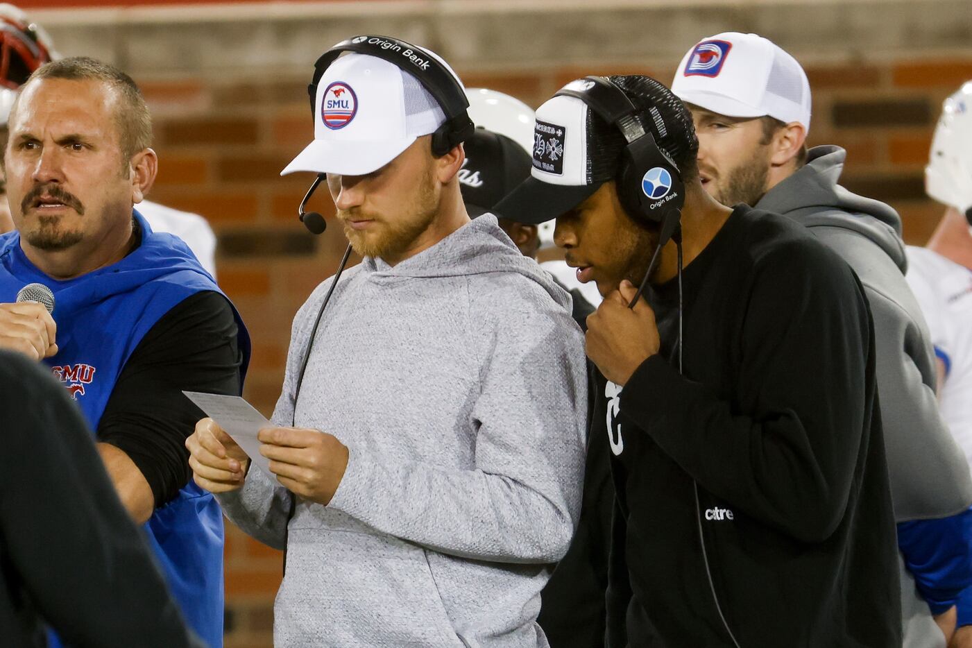 Former SMU players Kansas City Chiefs Quarterback Shane Buechele (center left) and Reggie...