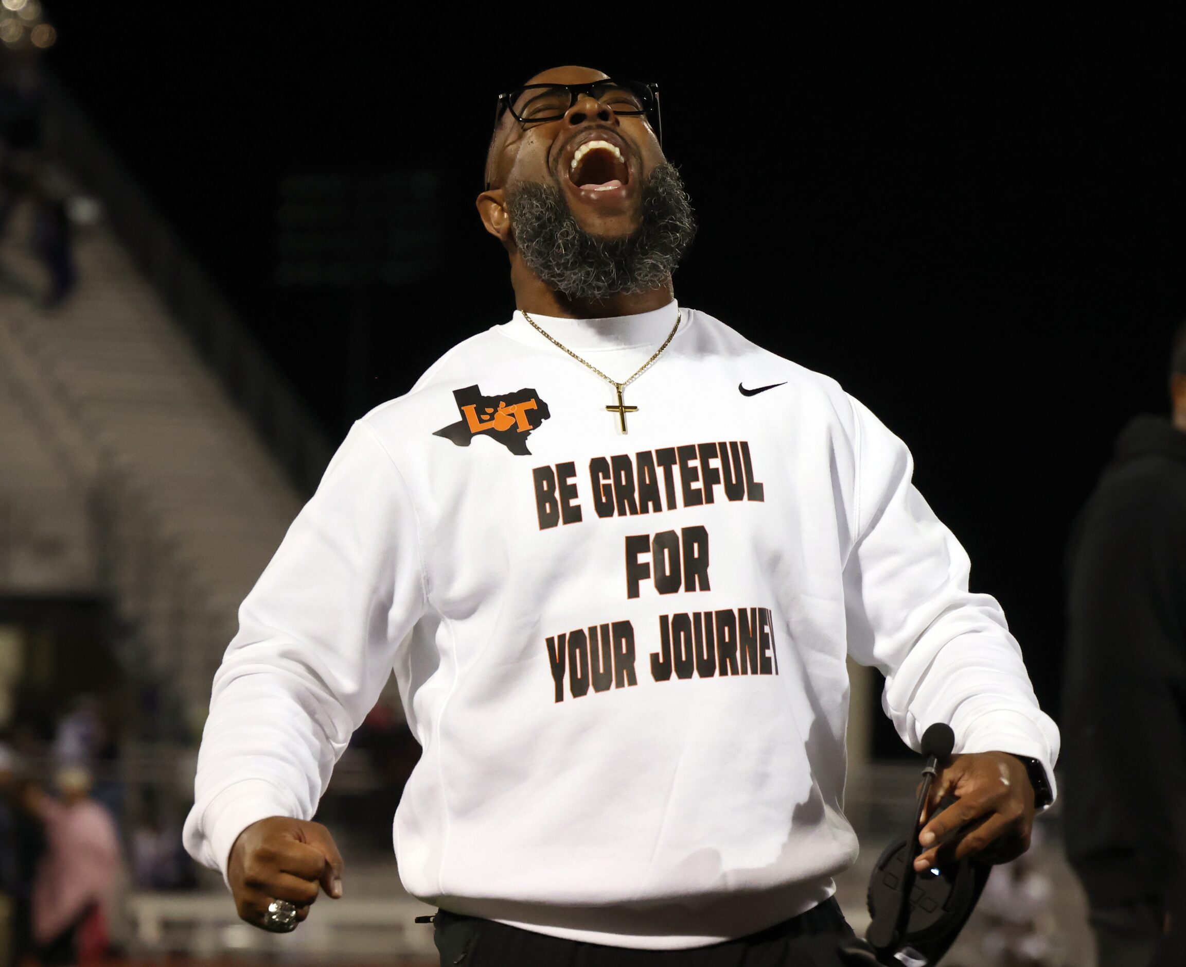 Lancaster head coach Leon Paul lets out a victory yell while speaking with his players on...