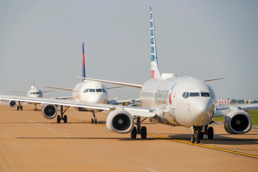 American Airlines and Delta Airlines planes line up for takeoff on Wednesday, Sept. 8, 2021,...