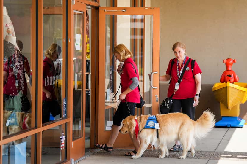 A golden retriever and its handlers from the Lutheran Church Charities K-9 Comfort Dog...
