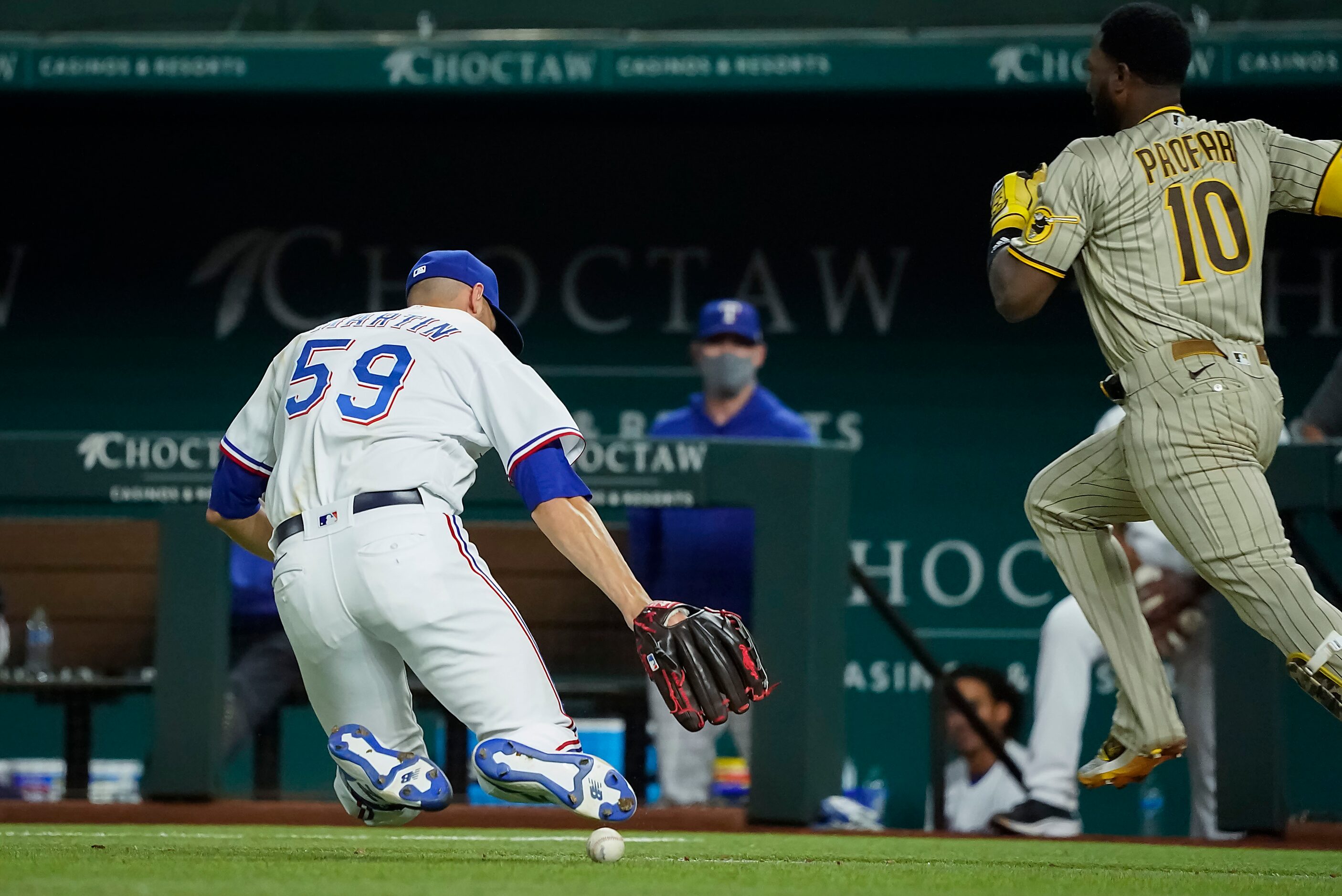 Texas Rangers pitcher Brett Martin can’t make the play on a single off the bat of San Diego...