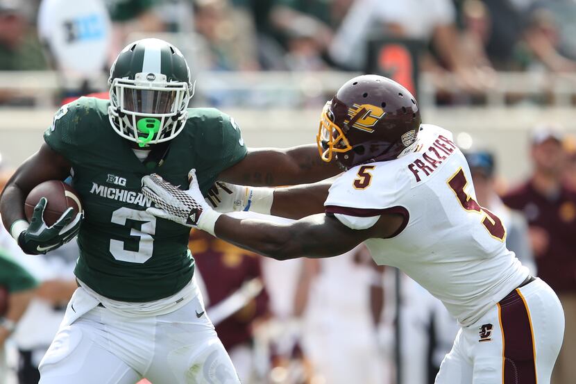 EAST LANSING MI - SEPTEMBER 26: LJ Scott #3 of the Michigan State Spartans runs for a first...