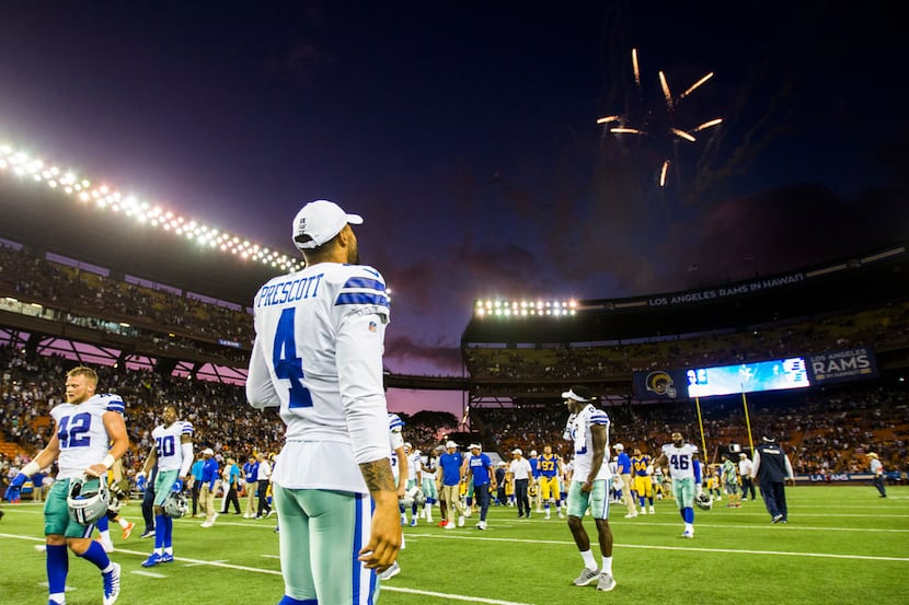 Dallas Cowboys quarterback Dak Prescott (4) walks off the field with fireworks after a 14-10...