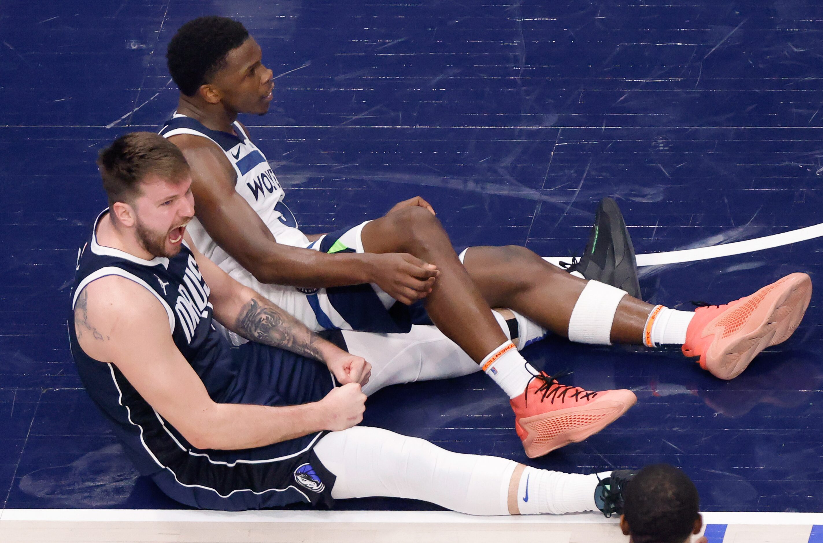 Dallas Mavericks guard Luka Doncic (77) reacts after drawing a charge from Minnesota...