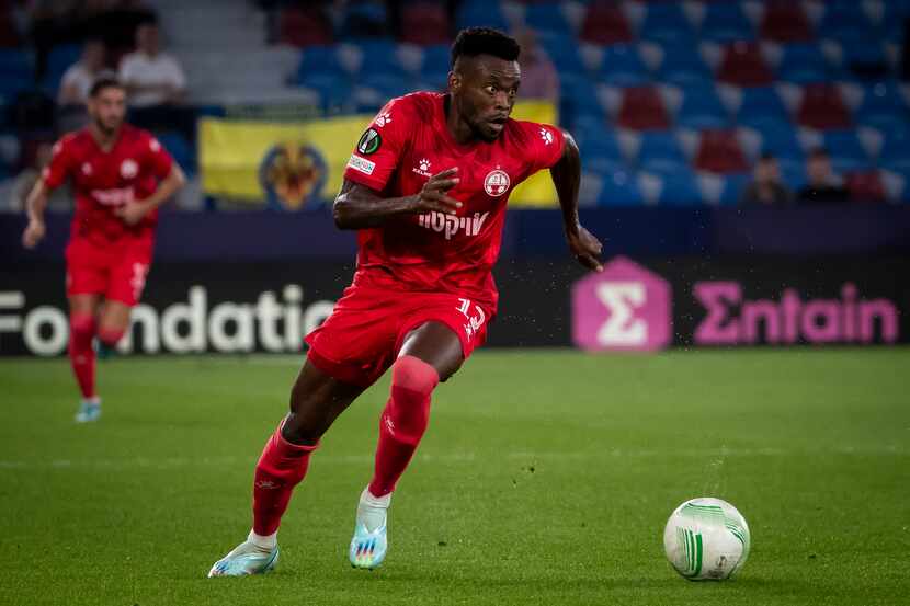 Hapoel Beer Sheva's Eugene Ansah dribbles during a UEFA Conference League match against...
