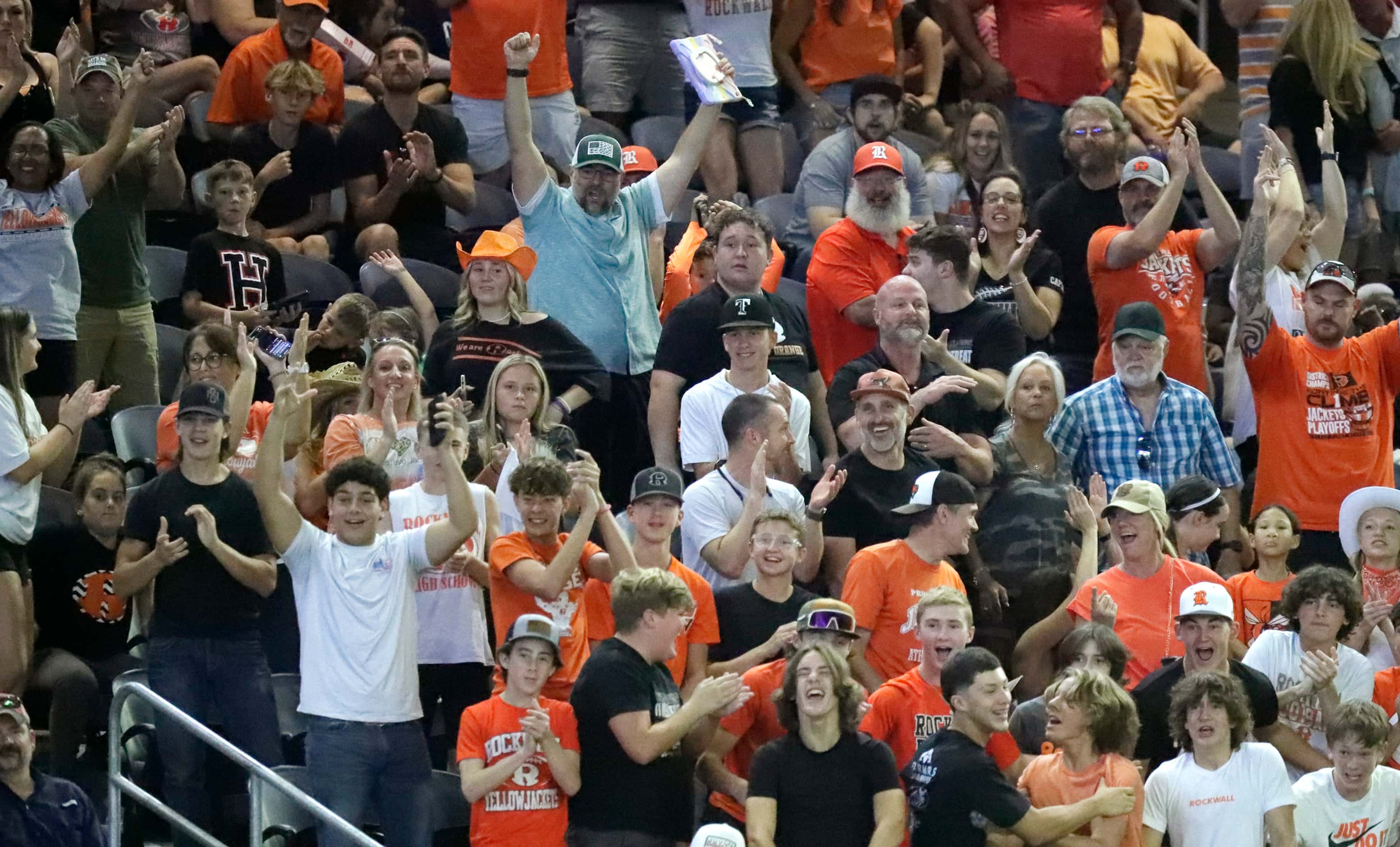 Rockwall High School fans celebrate a touchdown that would bring the score to 28-0 during...