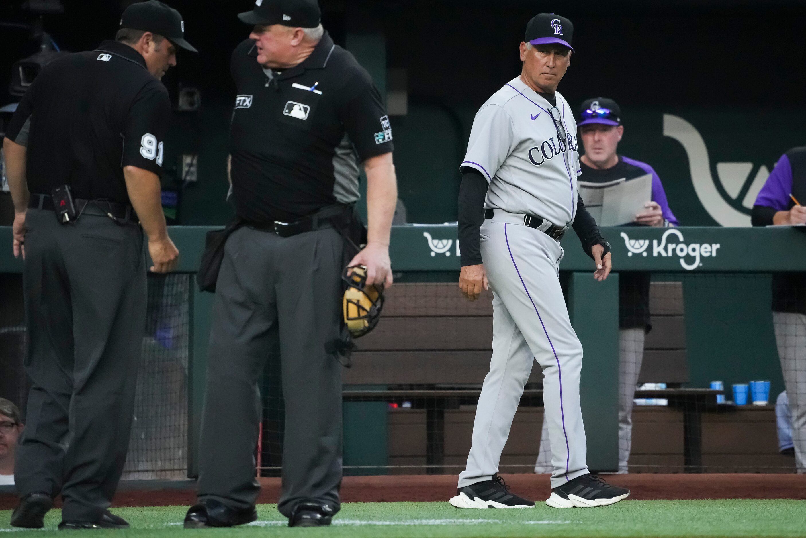 Colorado Rockies manager Bud Black walks back to the dugout after talking to umpires to...