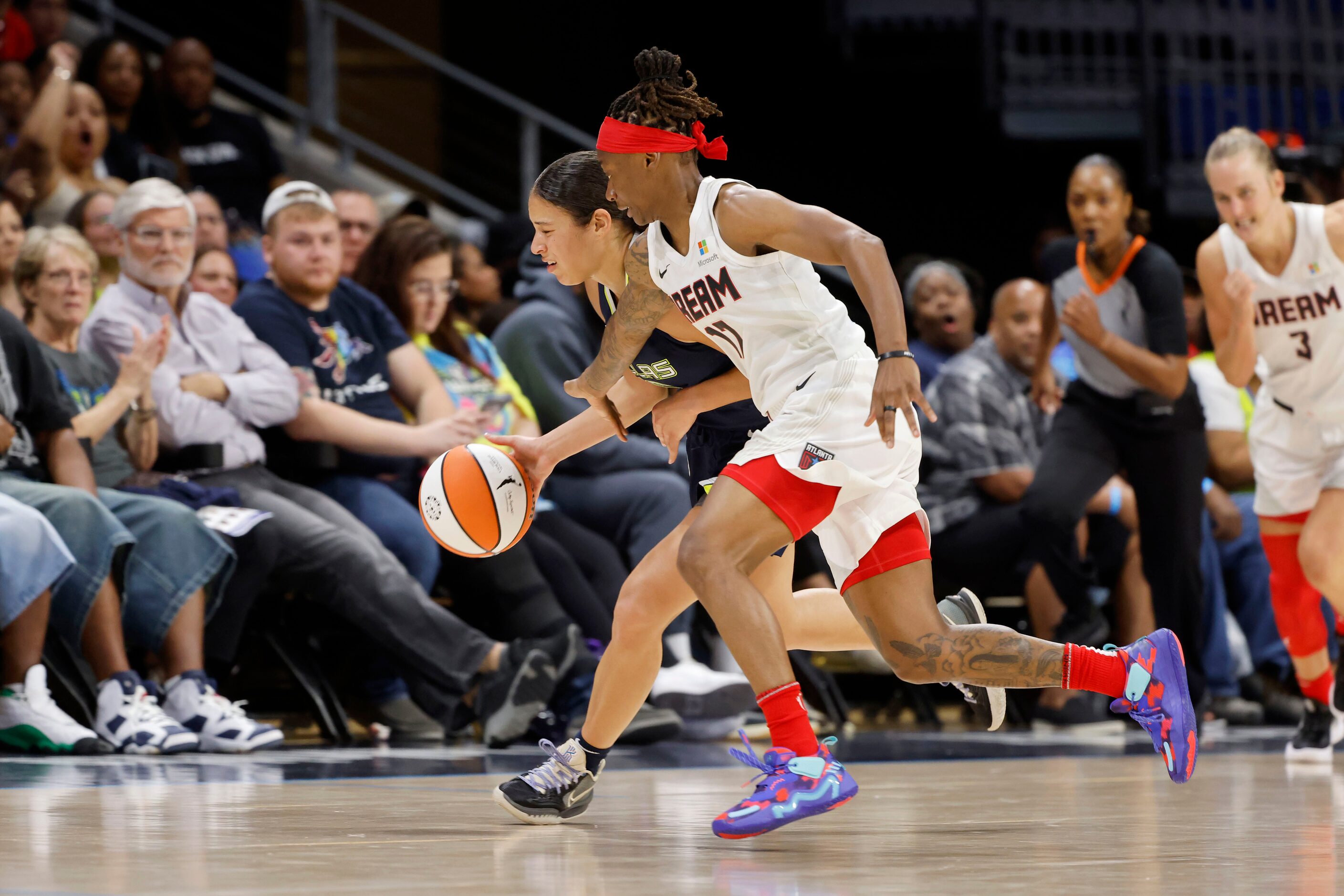 Dallas Wings guard Veronica Burton, left, is fouled by Atlanta Dream’s Erica Wheeler during...