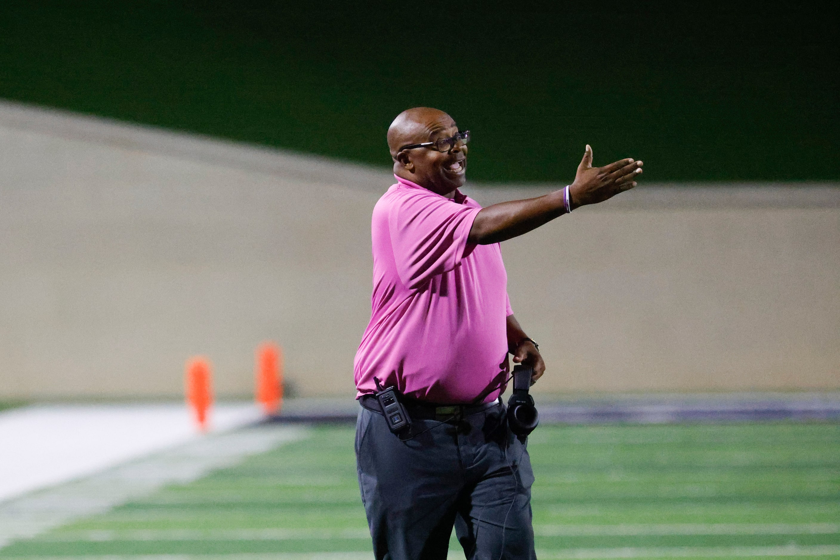 Crowley High head coach Carlos Lynn instructs the team against Trinity High during the first...